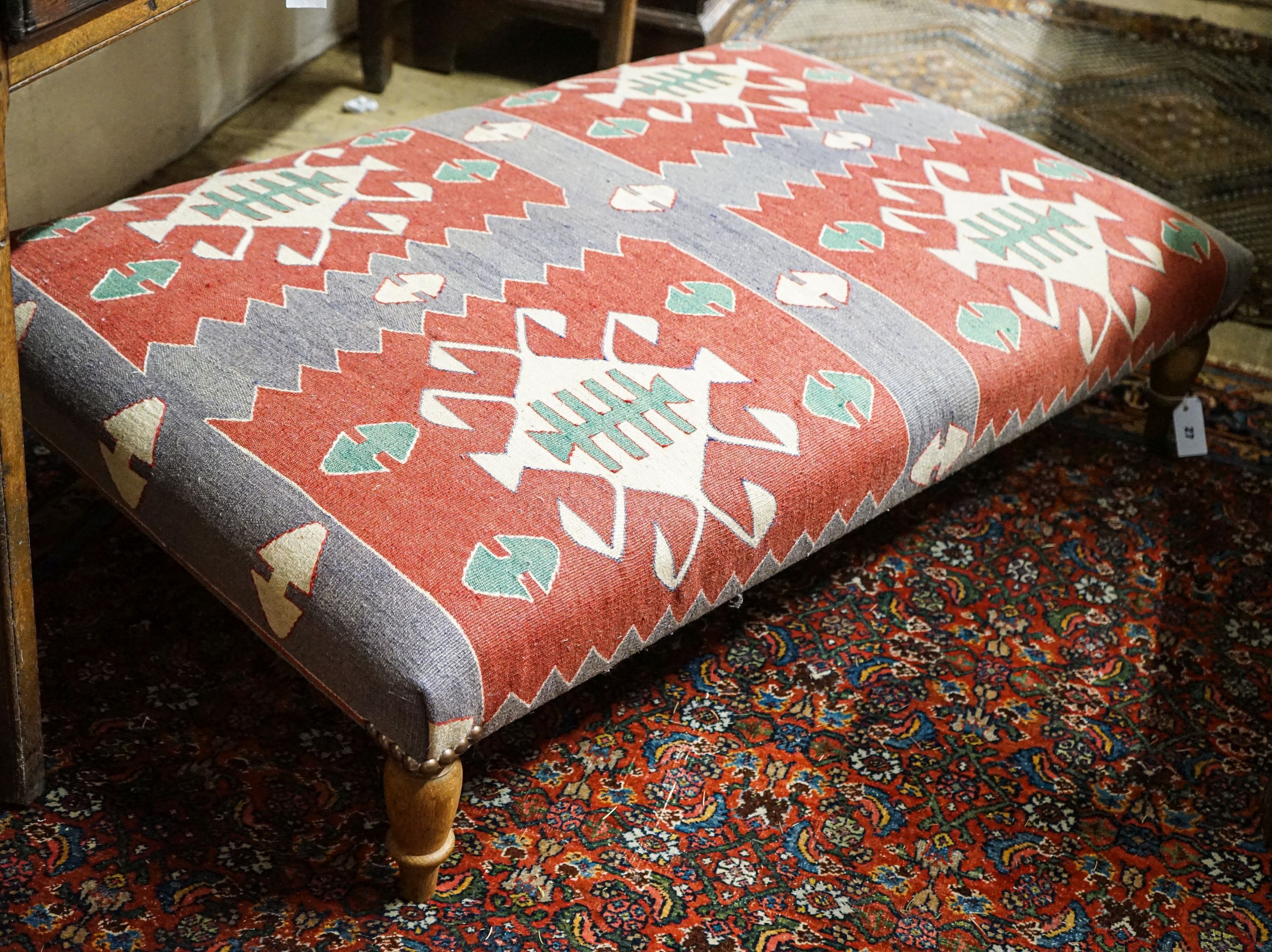 A large rectangular Kelim footstool on turned oak feet, length 124cm, depth 80cm, height 28cm